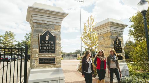 Students walking onto campus passed North Central College sign